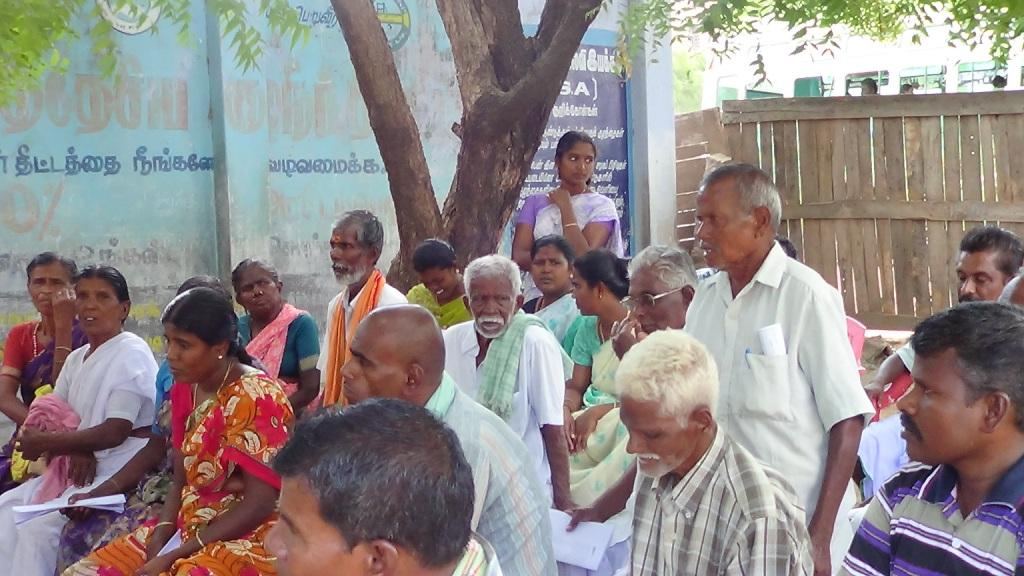 Women's self-help group members meeting outdoors under trees